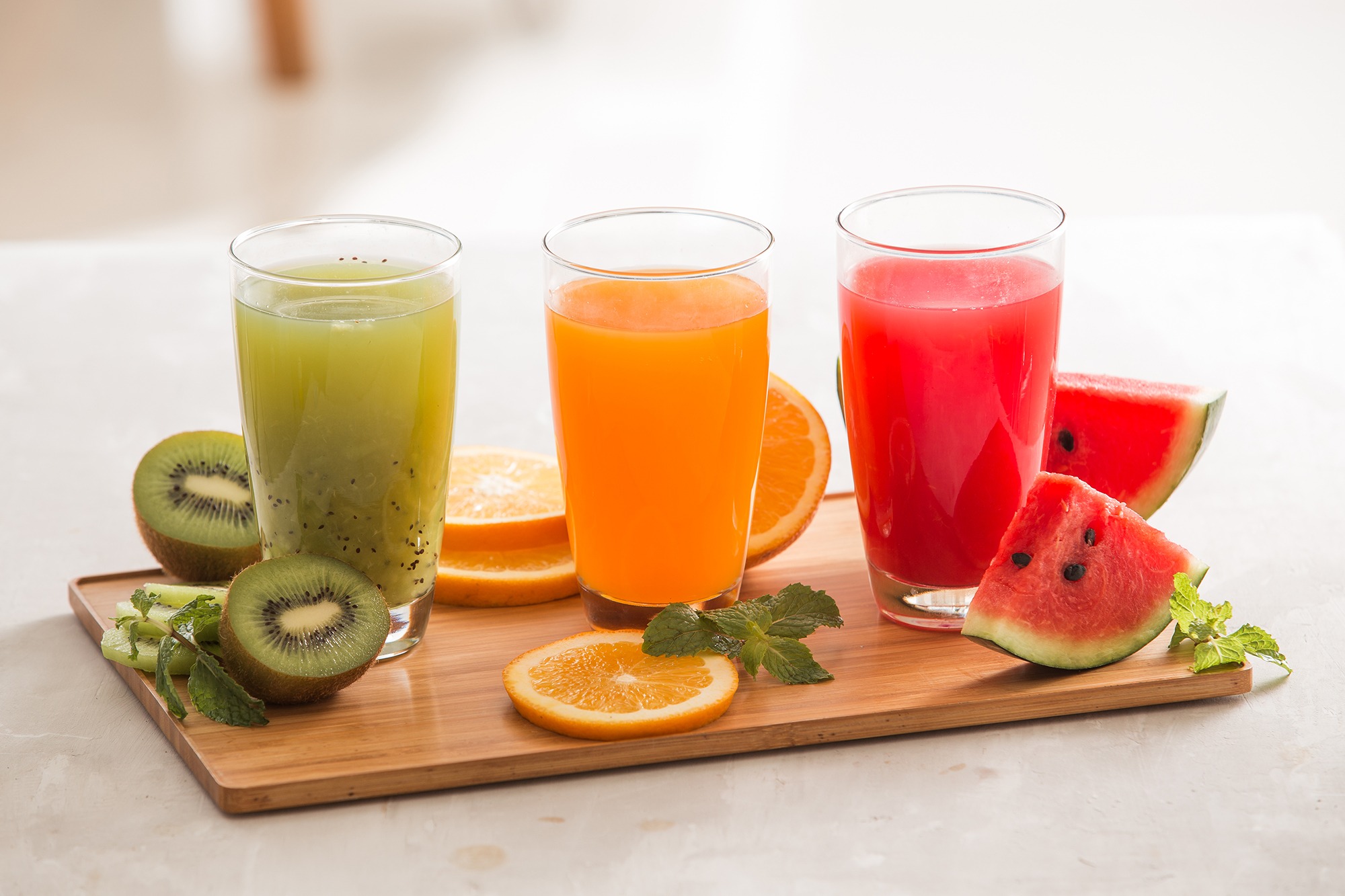Kiwi, orange and watermelon juices with fresh fruit